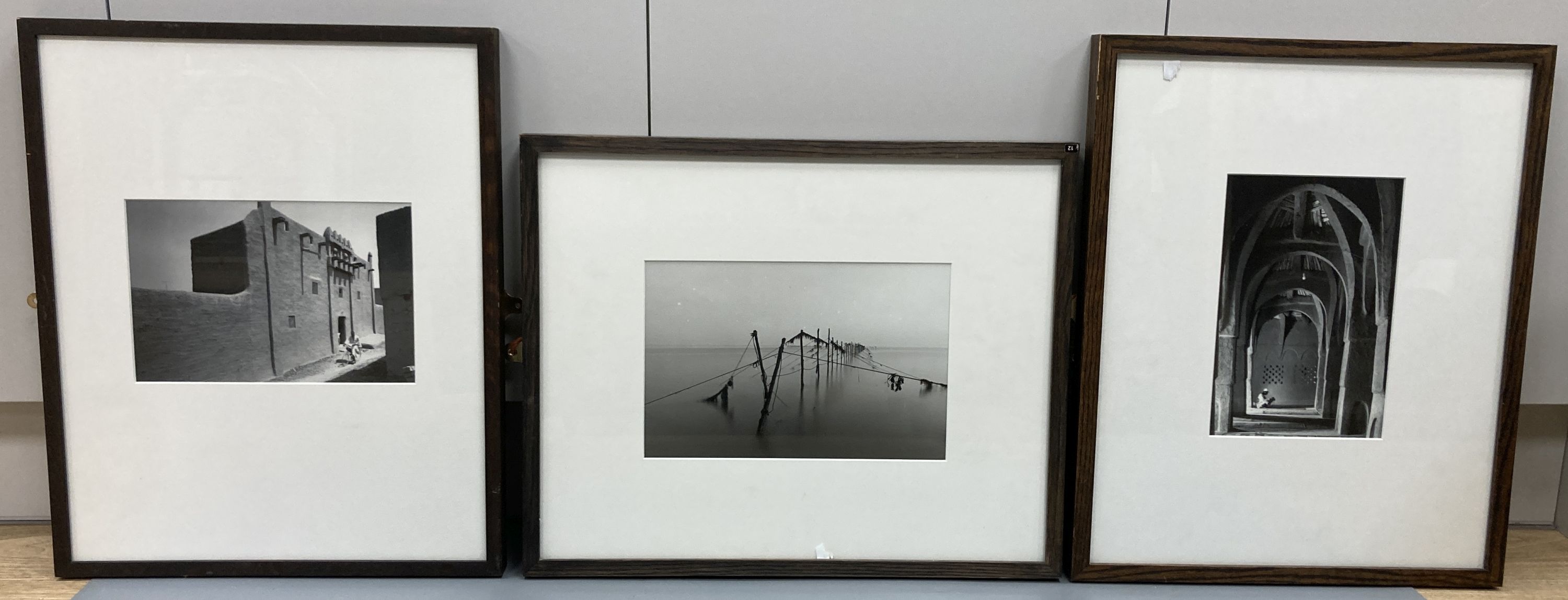 Three framed black and white photographs, North African mosque, Street scene and Fish traps, largest 26 x 17cm